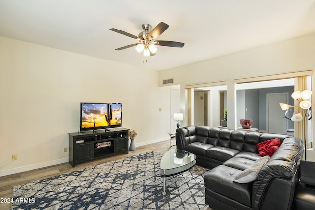 living room featuring ceiling fan and hardwood / wood-style floors