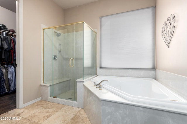 bathroom featuring tile patterned floors and separate shower and tub