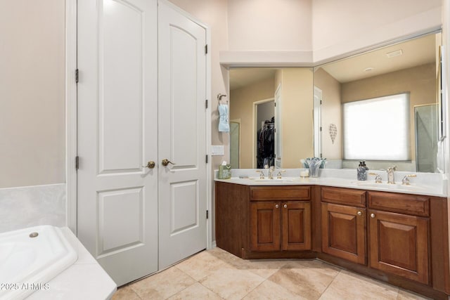 bathroom with vanity, tile patterned flooring, and a tub