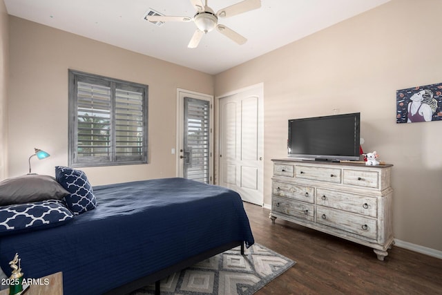 bedroom with dark hardwood / wood-style flooring and ceiling fan