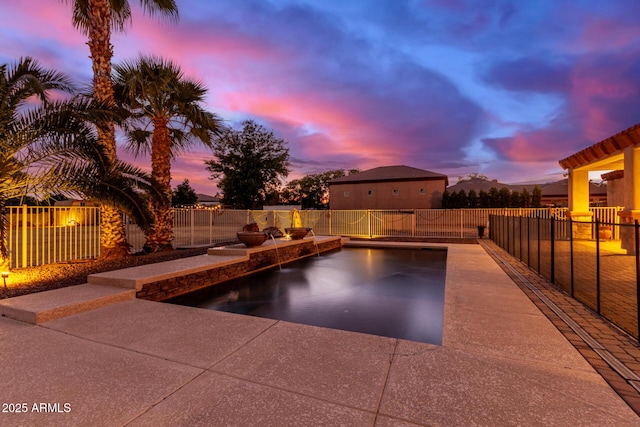 pool at dusk with a patio