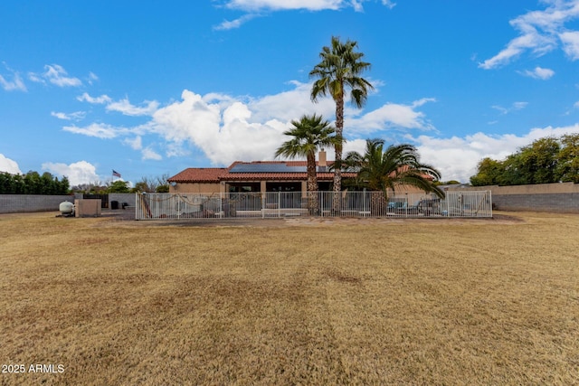 rear view of property featuring a yard