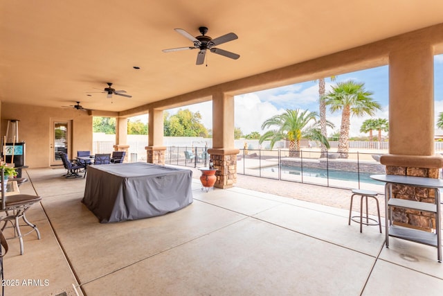 view of patio with a fenced in pool and ceiling fan