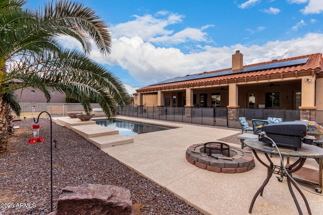 view of pool with a patio area and an outdoor fire pit