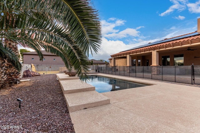 view of pool featuring ceiling fan and a patio area