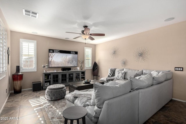 living room featuring tile patterned floors and ceiling fan