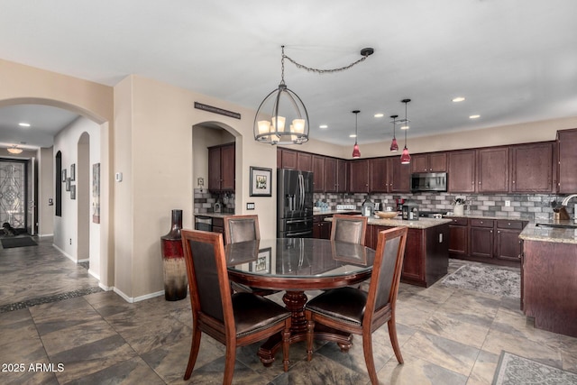 dining area featuring a notable chandelier and sink