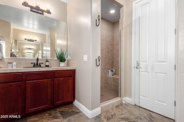 bathroom featuring vanity and an enclosed shower