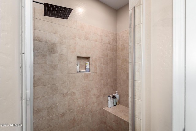 bathroom with a tile shower