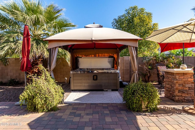 view of patio featuring a gazebo and a hot tub