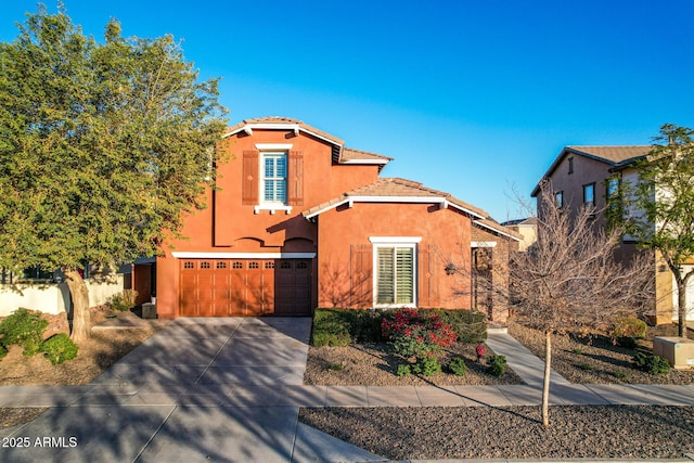 mediterranean / spanish-style home featuring a garage