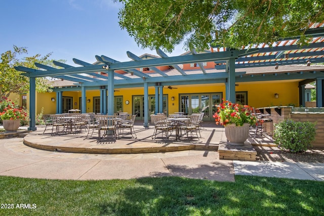 rear view of property with a pergola, a patio area, and ceiling fan