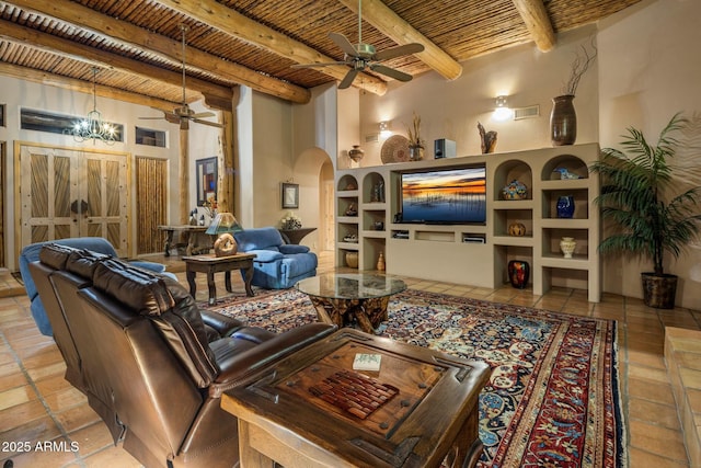 living room featuring built in shelves, ceiling fan, wood ceiling, and beamed ceiling