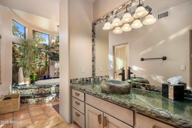 bathroom with vanity, tile patterned floors, and a tub to relax in