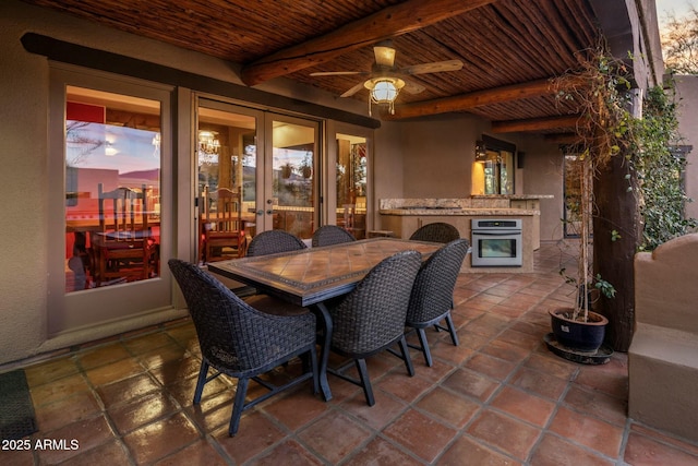 patio terrace at dusk with french doors and ceiling fan