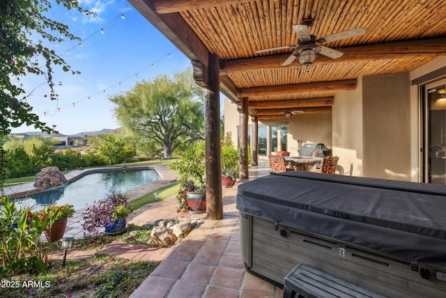 view of patio / terrace featuring ceiling fan and a pool with hot tub