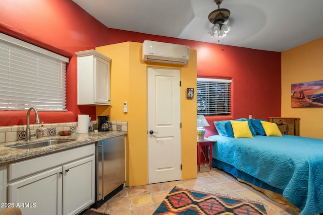 bedroom featuring sink, fridge, and an AC wall unit