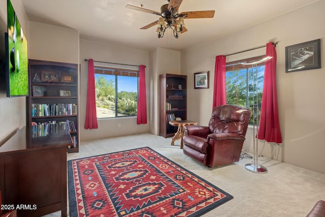 sitting room featuring light carpet and ceiling fan