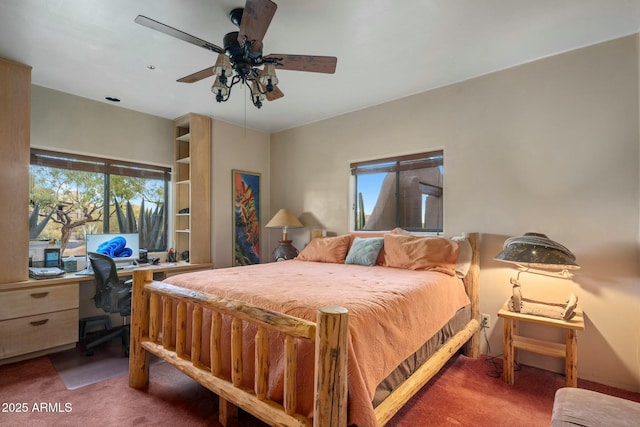 bedroom with ceiling fan, carpet flooring, and multiple windows