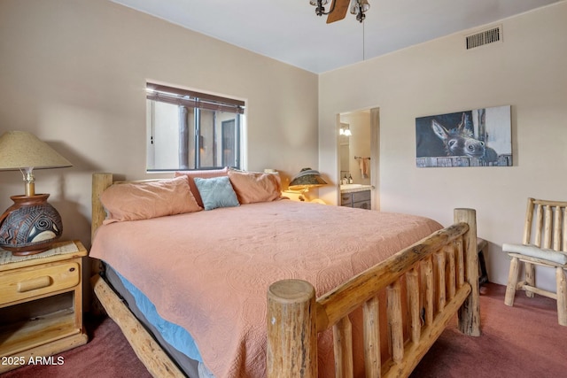 carpeted bedroom featuring ensuite bathroom and sink