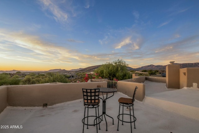 patio terrace at dusk with a mountain view