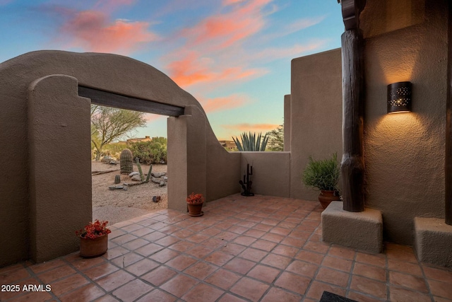 view of patio terrace at dusk