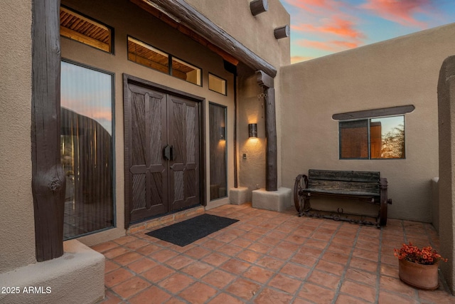 exterior entry at dusk with a patio