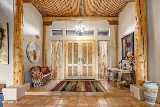 entrance foyer featuring wood ceiling, beam ceiling, tile patterned flooring, and a notable chandelier