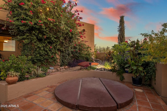 view of patio terrace at dusk