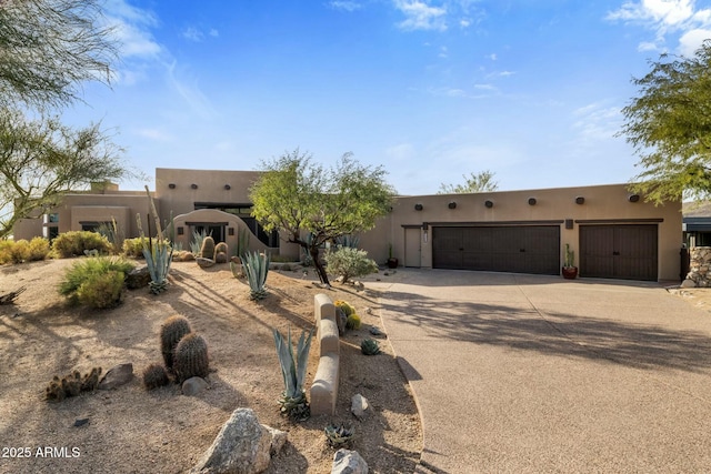 pueblo-style home featuring a garage