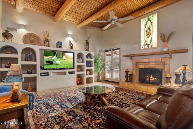 tiled living room featuring beamed ceiling, a tile fireplace, wooden ceiling, and built in shelves