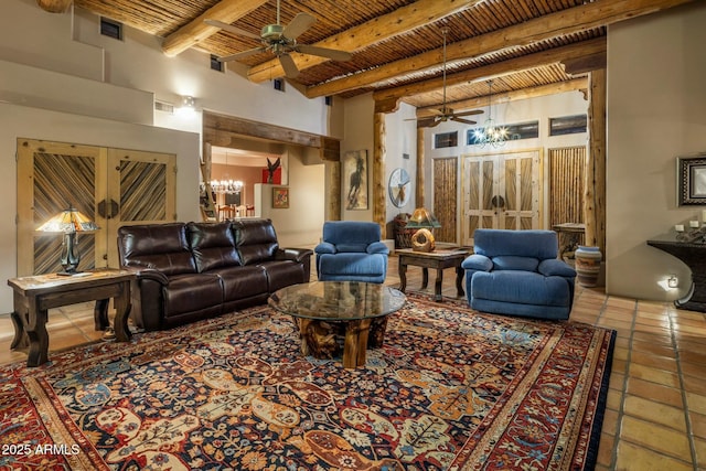 living room featuring beam ceiling, ceiling fan with notable chandelier, wooden ceiling, and tile patterned floors