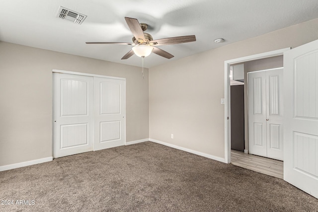 unfurnished bedroom featuring ceiling fan, carpet flooring, and a closet