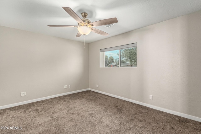 spare room featuring ceiling fan and carpet