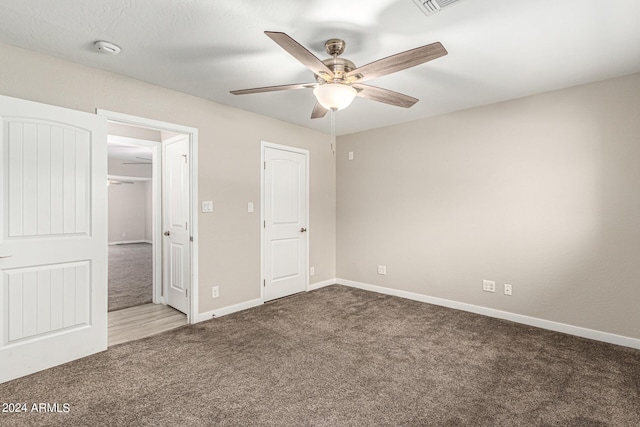 unfurnished bedroom featuring ceiling fan and carpet flooring