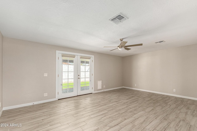 spare room with french doors, ceiling fan, light hardwood / wood-style flooring, and a textured ceiling