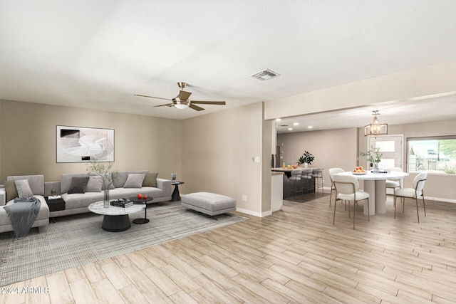 living room featuring ceiling fan and light hardwood / wood-style floors