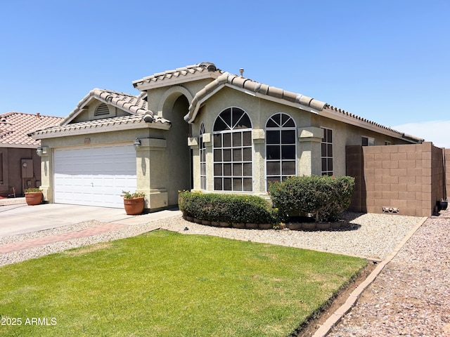 3418 W Maldonado Rd, Phoenix, AZ 85041 - view of front of home with an attached garage, stucco siding, concrete driveway, and a tiled roof