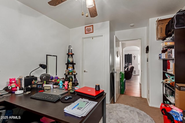 3418 W Maldonado Rd, Phoenix, AZ 85041 - carpeted home office with a ceiling fan, arched walkways, and baseboards