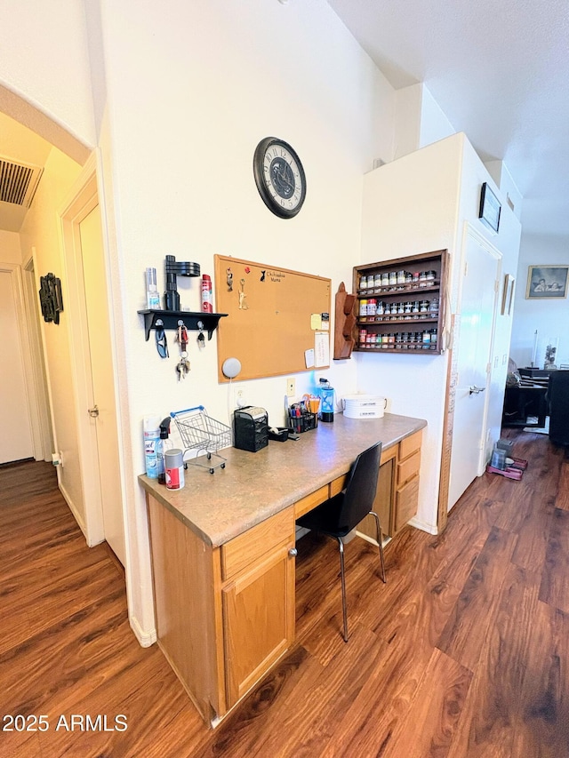 3418 W Maldonado Rd, Phoenix, AZ 85041 - home office with dark wood-type flooring and built in desk