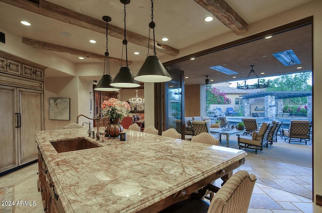 dining room featuring recessed lighting, stone tile floors, beam ceiling, and an inviting chandelier