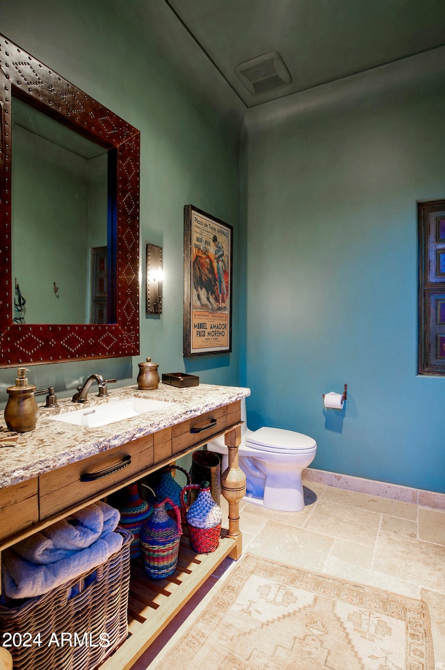 bathroom featuring toilet and vanity