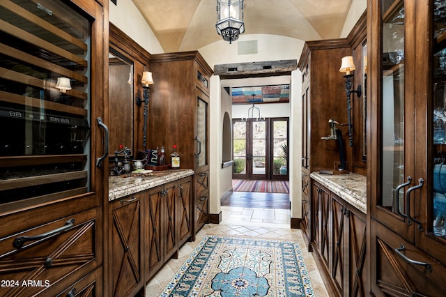 bathroom featuring lofted ceiling, tile patterned flooring, vanity, and french doors