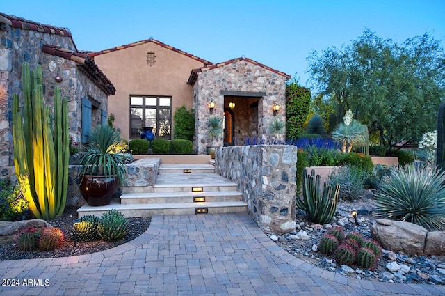 view of front facade with stone siding and stucco siding