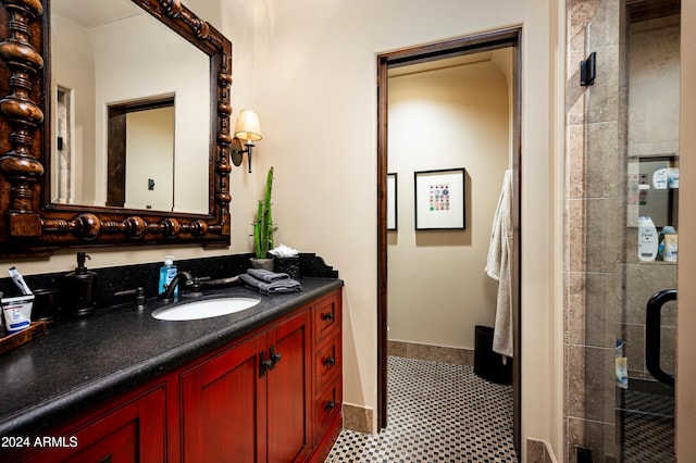 bathroom featuring vanity, tile patterned floors, and tiled shower