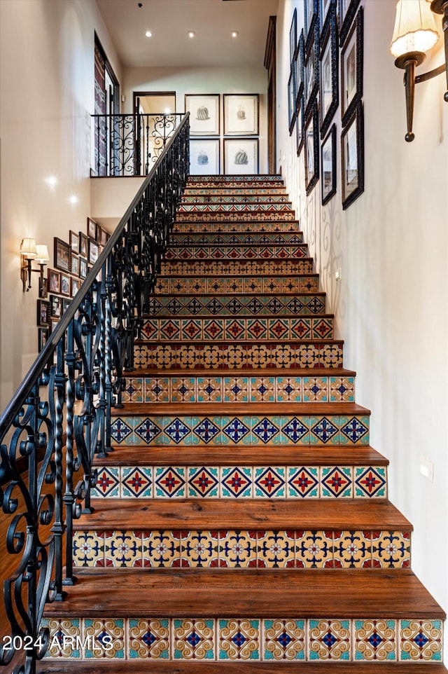 staircase with a towering ceiling