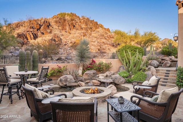 view of patio with a mountain view and a fire pit