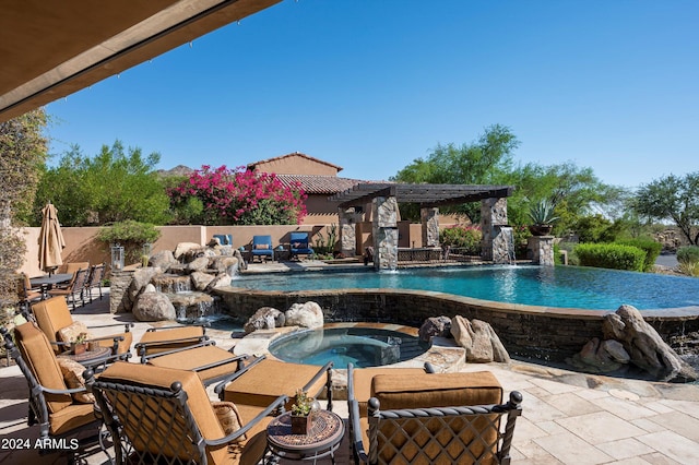 view of pool with a patio, an infinity pool, and an in ground hot tub