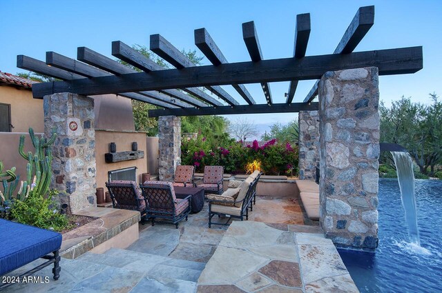 view of patio with an outdoor living space with a fireplace and a pergola