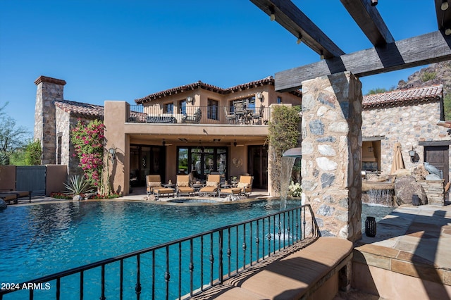 view of pool featuring a patio area, pool water feature, and an outdoor hangout area